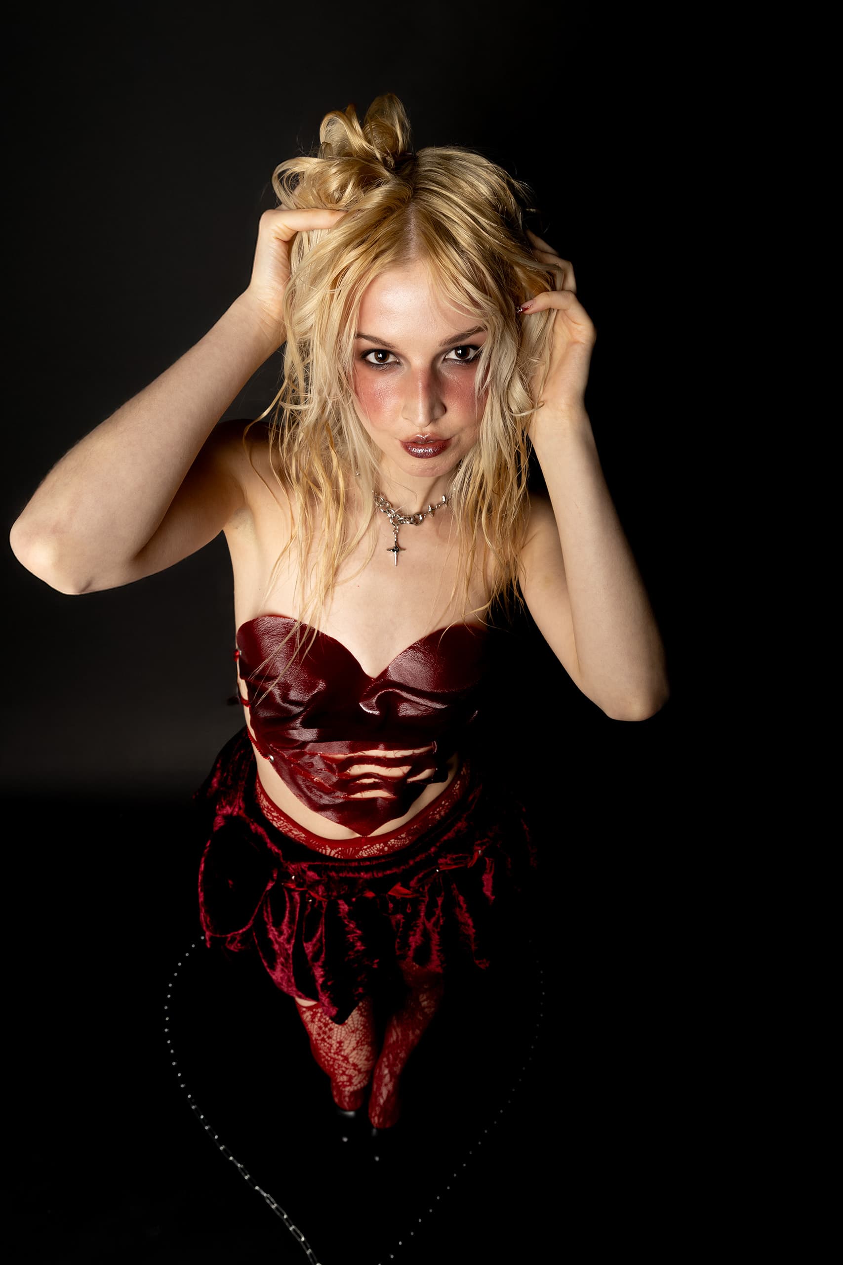© 2026 Linh Chi Nguyen & Thanh Van Nguyen — Dramatic close-up of the red leather couture look and fashion makeup.