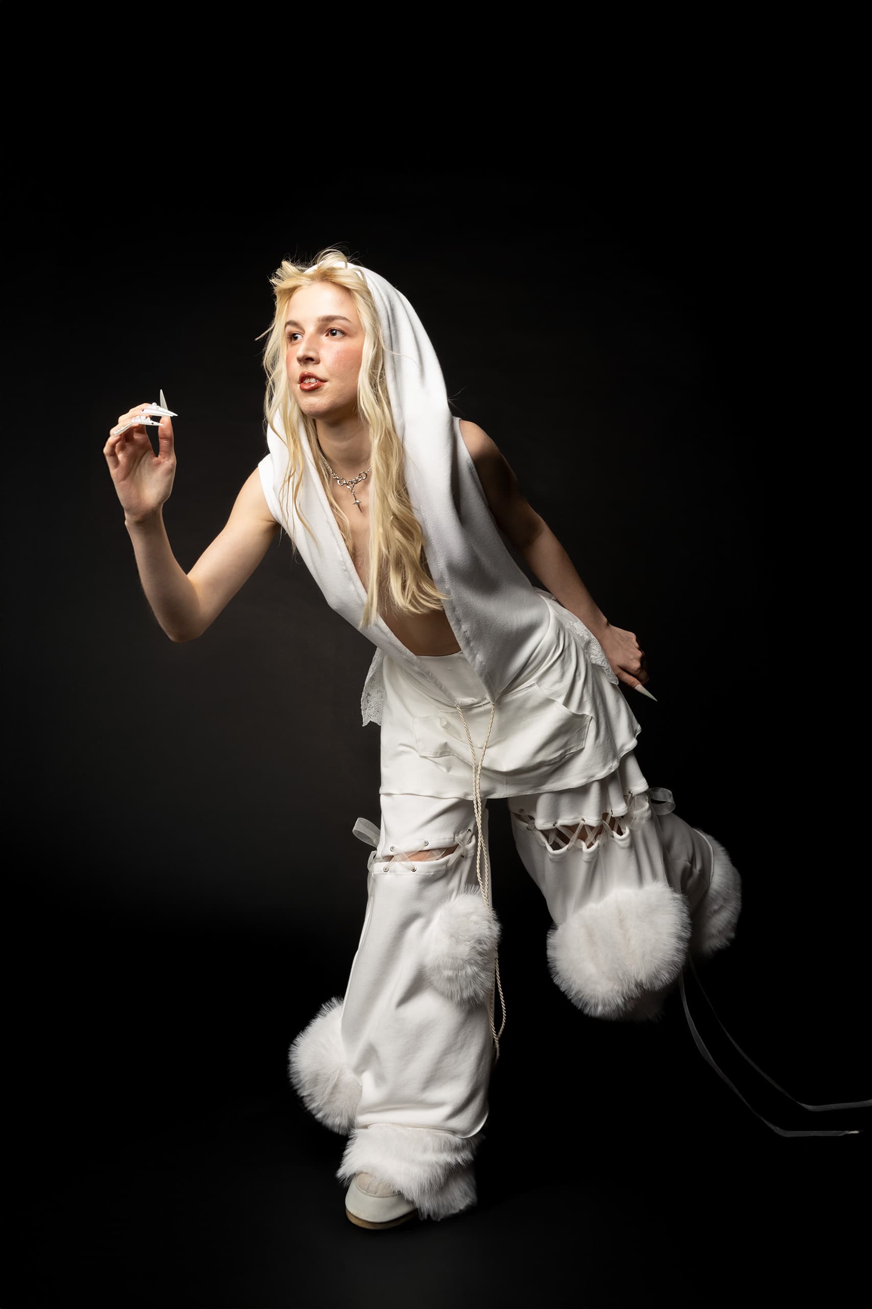 © 2026 Linh Chi Nguyen & Thanh Van Nguyen — The Running Bride: Bridal action shot in fur-trimmed trousers