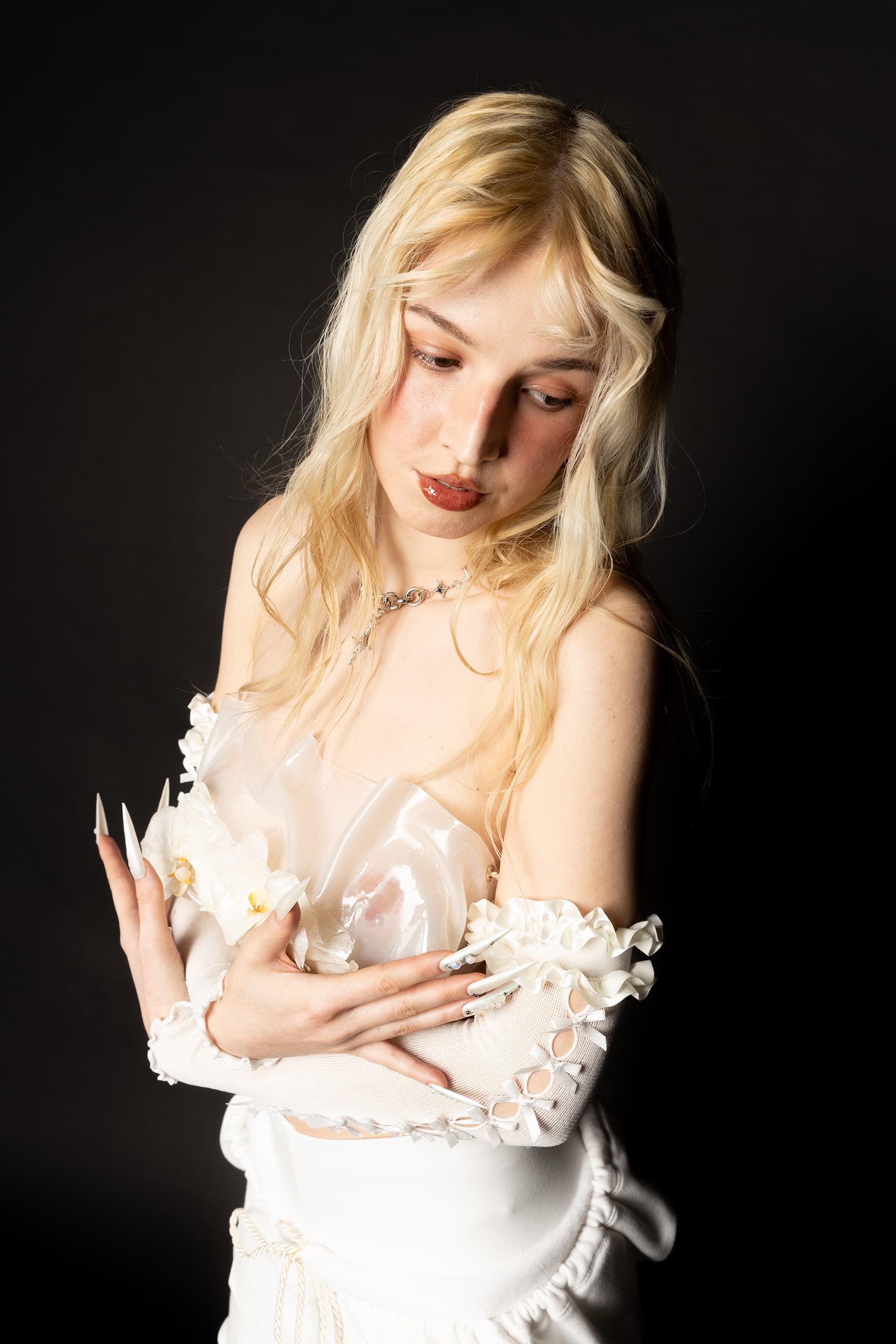 © 2026 Linh Chi Nguyen & Thanh Van Nguyen — Detail shot of handcrafted floral appliqué and white mesh sleeve textures.
