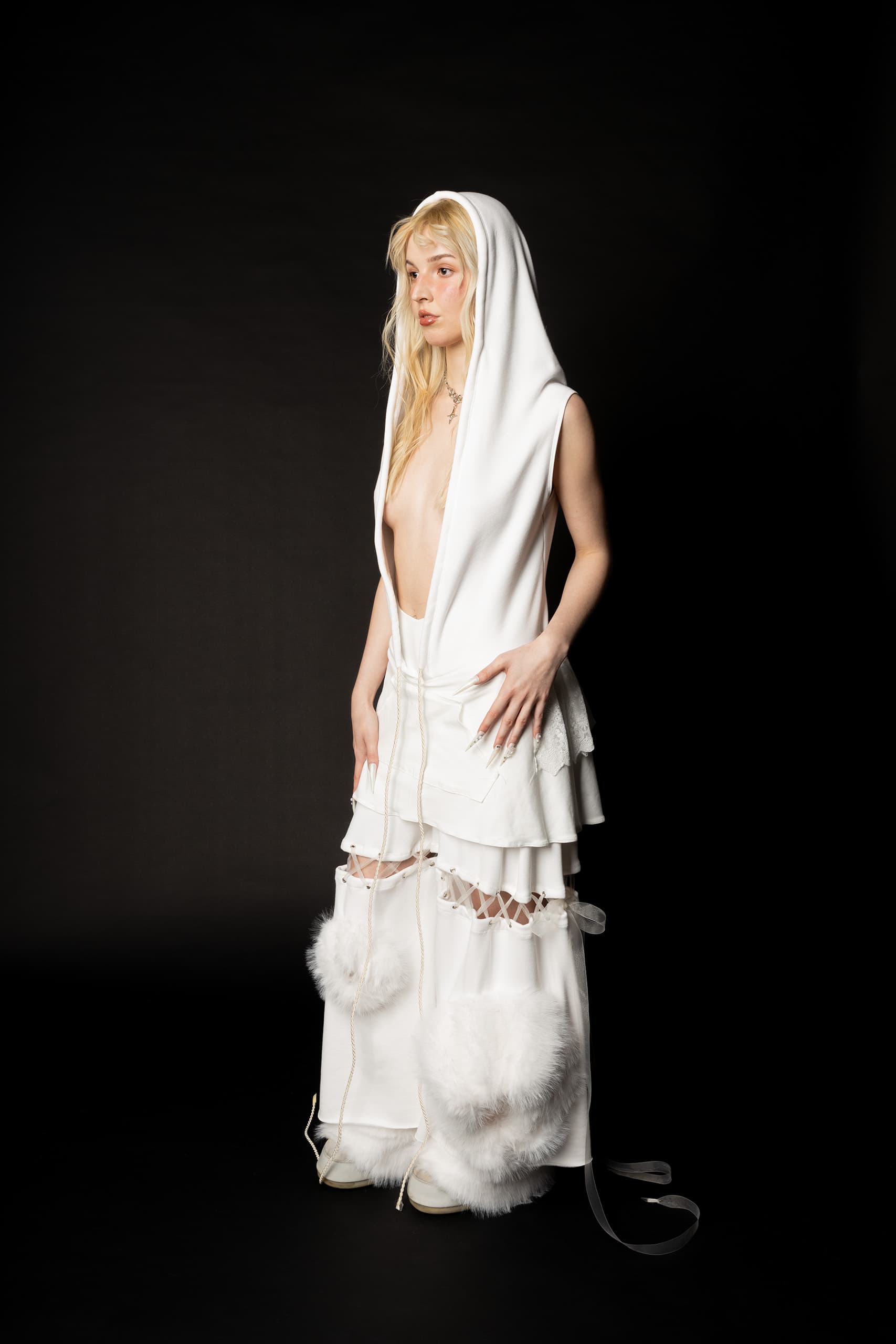 © 2026 Linh Chi Nguyen & Thanh Van Nguyen — The Running Bride: Side profile of layered hooded ensemble